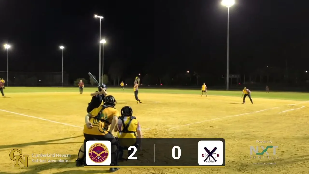 A pitch mid-delivery in a live Friday night Mens Fastpitch game, streamed by Cumberland Live with the score and club logos on screen